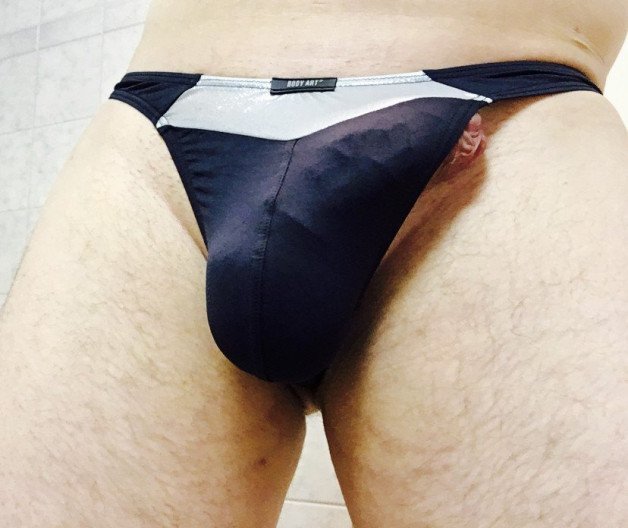 Photo by thoughtfulenjoyment with the username @thoughtfulenjoyment, who is a verified user,  February 2, 2022 at 9:38 PM. The post is about the topic Men in Underwear and the text says 'enjoying my silver black thong with a peak of 🍆'
