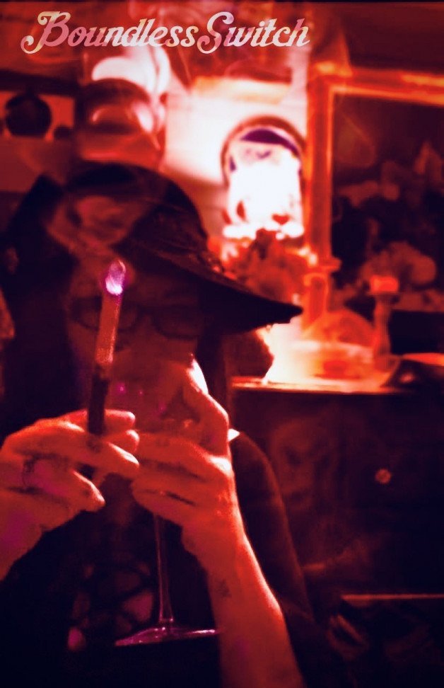 Photo by SwitchForHer with the username @SwitchForHer,  March 5, 2022 at 8:20 PM. The post is about the topic Smoking women and the text says '#boundlessswitch, #smoking, #cigaretteholder, #mistress, #wine, #hat'