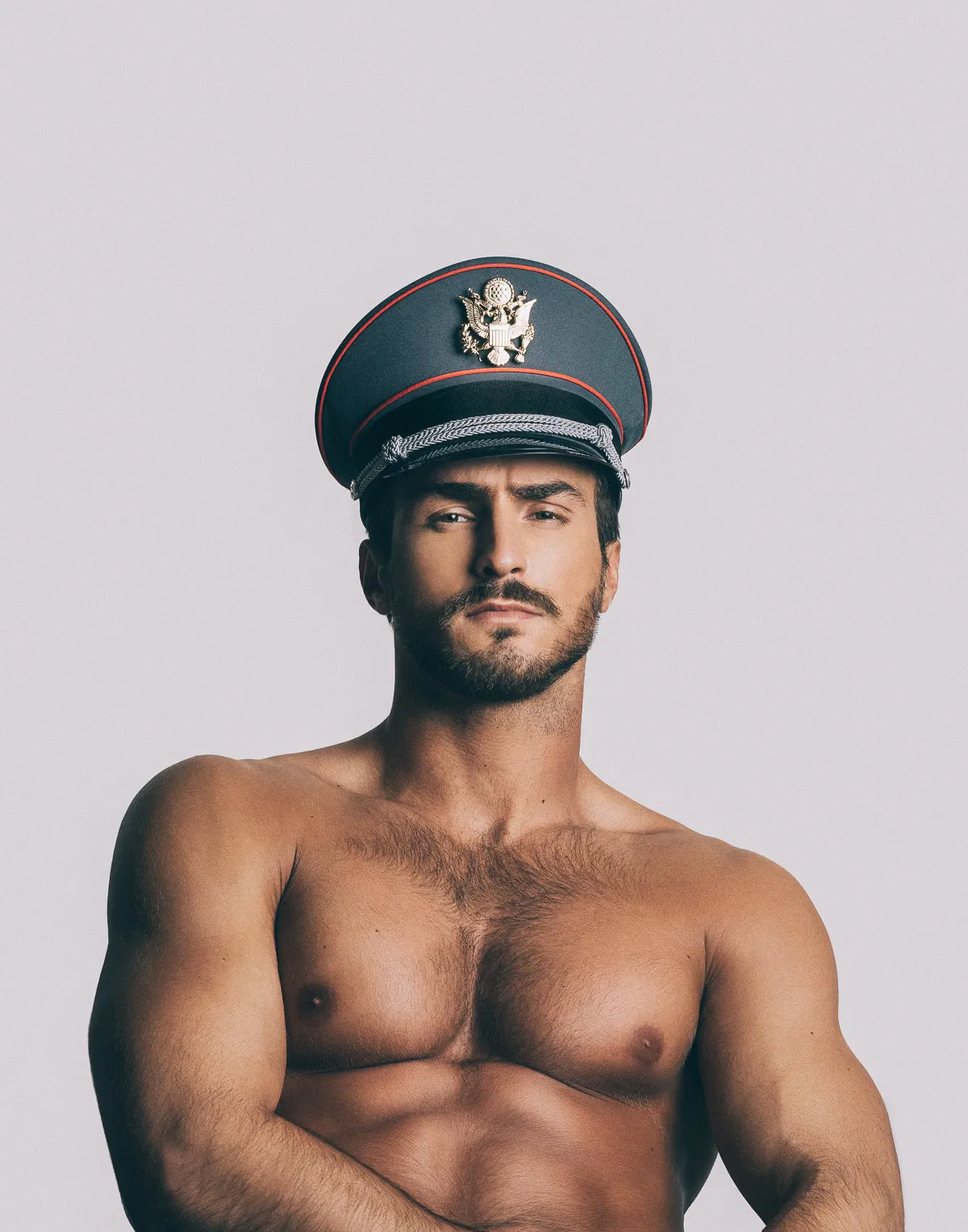 Photo by Schadenfreude with the username @Schadenfreude,  January 31, 2017 at 10:11 PM and the text says 'brianjamie:
Tarik Kaljanac by @brianjamie
 #gay  #nazi  #male  #beefcake  #hat  #stare  #glare  #seated'