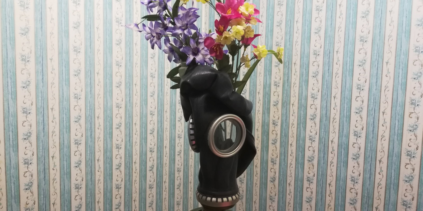 Photo by CatBoi with the username @CatBoi, who is a verified user,  December 30, 2018 at 6:28 PM. The post is about the topic GAY - Gas masks and the text says '#gasmask #mask #flowers #art #foundobjects'