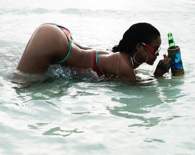 Photo by urodisco with the username @urodisco,  August 23, 2018 at 2:00 AM and the text says 'Bottle’s empty - who’s gonna hold it for Rihanna to refill? #rihanna  #beach  #water  #bottle  #smoke  #drink  #fill  #butt  #pose  #sexy  #hot  #wer'