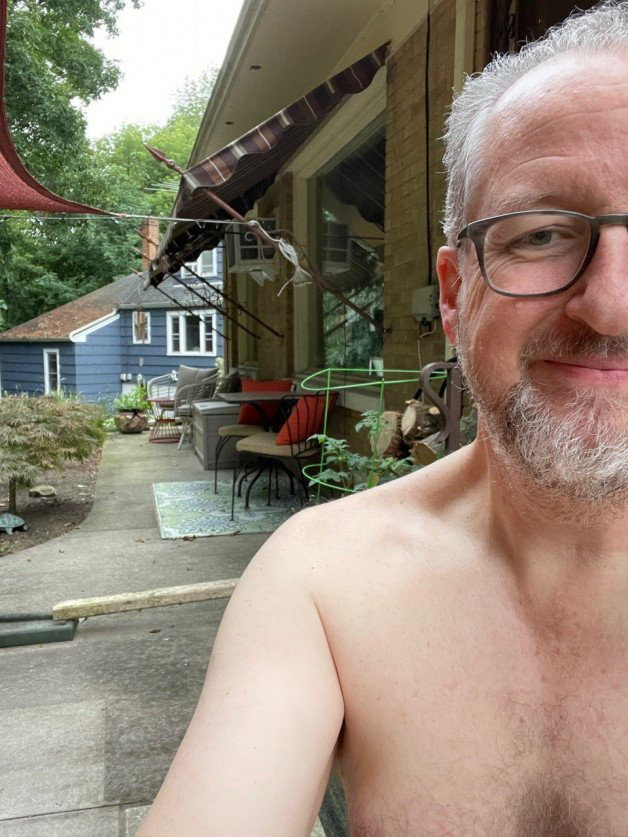 Photo by IntelligentGear3358 with the username @IntelligentGear3358, who is a verified user,  October 10, 2022 at 7:05 PM and the text says 'Home, patio, and yard nudist and exhibitionist. Bottomless coffee, topless refills'