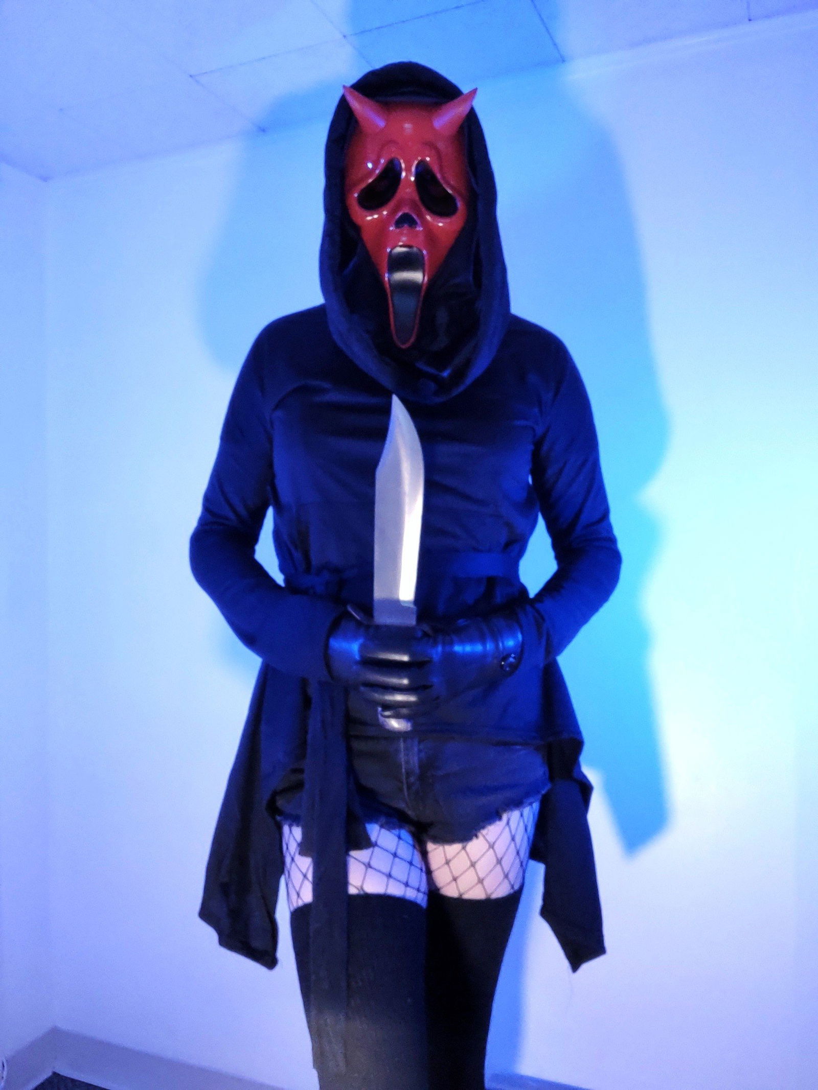 Album by SuccubusTyranna with the username @SuccubusTyranna, who is a verified user,  October 13, 2022 at 4:00 PM and the text says 'Isn't Halloween just the best time of the year? 😏🖤
#halloween #harness #bdsm #mask #goth'