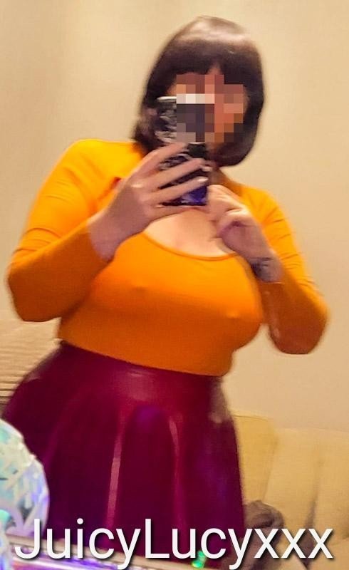 Photo by Juicylucy38xxx with the username @Juicylucy38xxx, who is a verified user,  December 9, 2023 at 8:47 PM. The post is about the topic JuicyLucy38xxx and the text says 'My Velma Dinkley outfit. Not the best pic and wasn't happy with stockings or top. Latex Plum coloured skirt was nice, plus the brunette wig and geeky glasses. 
Hoping Santa buys me the Latex orange top and Stockings off my Wishtender link on my profile..'