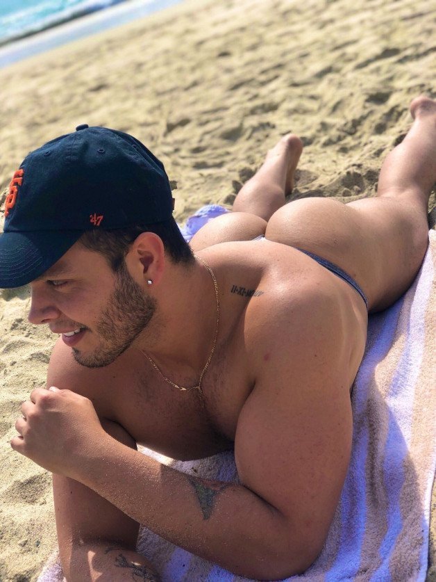 Photo by mike50667 with the username @mike50667, who is a verified user,  January 1, 2024 at 9:47 AM. The post is about the topic GoOutdoors and the text says '#goOutdoors, #beach, #ocean, #ass, #biceps, #butt, #cap, #sand, #speedo, #string, #thong'