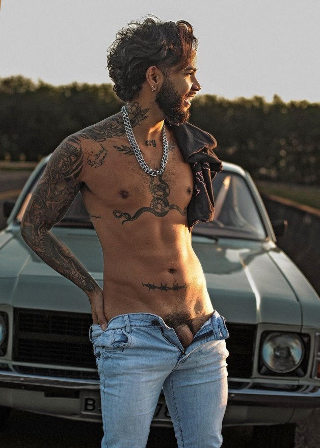 Photo by mike50667 with the username @mike50667, who is a verified user,  January 10, 2024 at 8:58 AM. The post is about the topic GoAuto and the text says '#goAuto, #car, #outdoors, #jeans, #dick, #cock, #tattoo, #beard, #smile, #laugh, #shirtless, #pose'