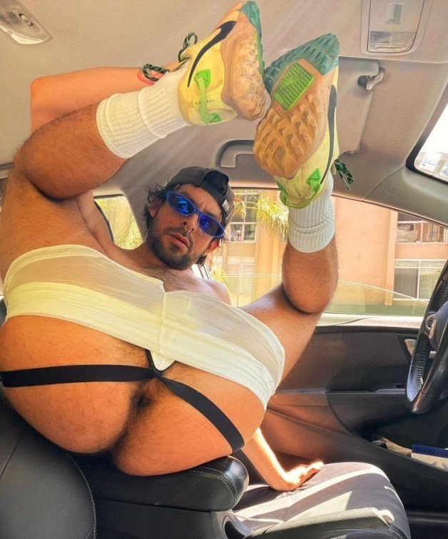 Photo by mike50667 with the username @mike50667, who is a verified user,  February 6, 2024 at 8:52 AM. The post is about the topic GoAuto and the text says '#goAuto #car #driver #bottom #leg #ass #butt #asshole #sneakers #shades #beard #pose #cap #jockstrap #shorts #socks #hairy'