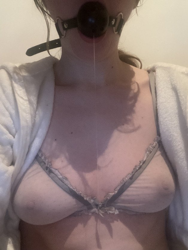 Photo by DollyErotika with the username @DollyErotika, who is a verified user,  January 10, 2024 at 12:12 PM and the text says 'cozy and gagged 🎀🖤'