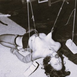 Photo by PiperMonroe with the username @PiperMonroe, who is a verified user,  May 5, 2024 at 8:23 PM. The post is about the topic Masochism and the text says 'Extreme #bondage, a woman's breasts lifted by weighted chains. #vintage #masochism'