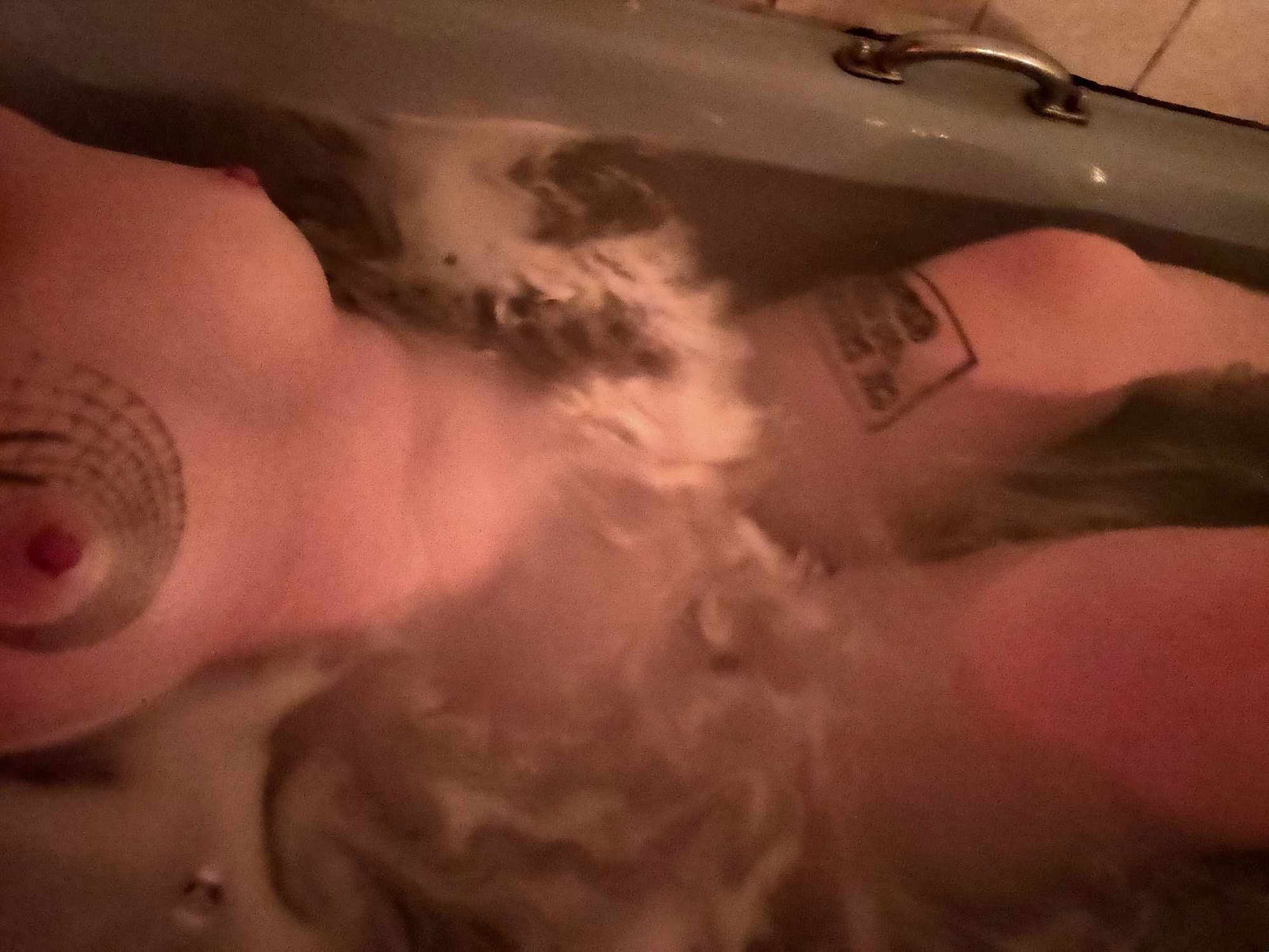 Album by DionysusZenunim with the username @DionysusZenunim, who is a star user,  September 24, 2023 at 6:00 PM. The post is about the topic Anarchist Punk Trans Man and the text says 'Kinky Queer Anarchist Punk Trans Man relaxing in a candlelit bath, listening to Folk Punk (Apes of the State to be specific) after a hard day causing trouble and fighting fascism!!!'