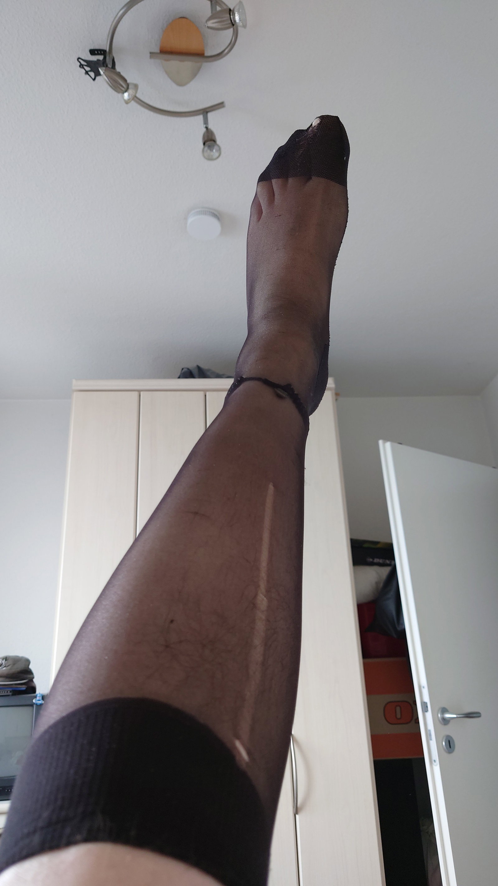 Photo by Carmen Nylonjunge with the username @Nylonjunge, who is a verified user,  May 10, 2024 at 3:19 PM and the text says 'These fine stockings were lying around in a drawer somewhere. When I put it on I noticed runs and holes. But my cock had fun putting it on and wearing it - and my feet also looked very COOL and SEXY in it. I'm already a horny slut for nylons'