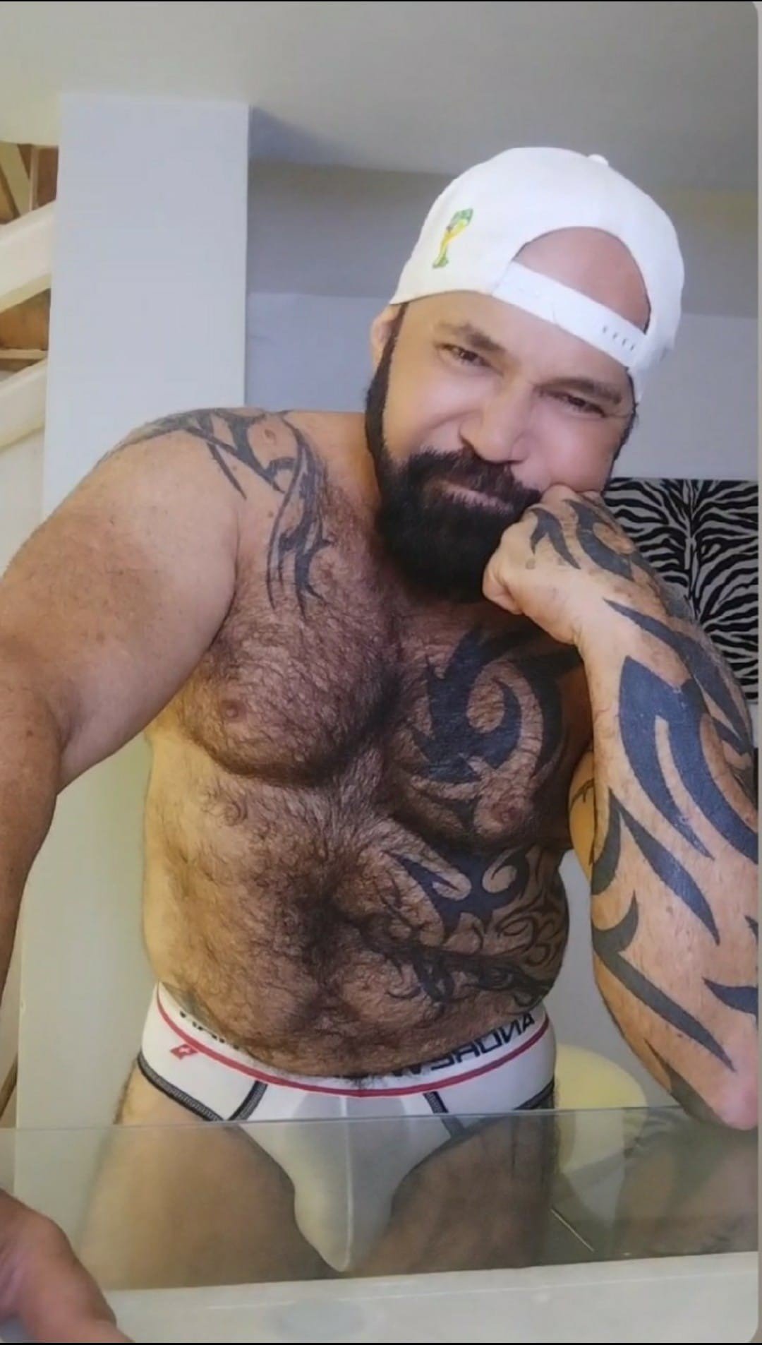 Album by DirtyDaddyFunStuff with the username @DirtyDaddyPorn, who is a verified user,  March 5, 2024 at 12:19 AM and the text says 'Sheer Shorts and #tats #bear .  #hairy #beards #armpits #stocky'