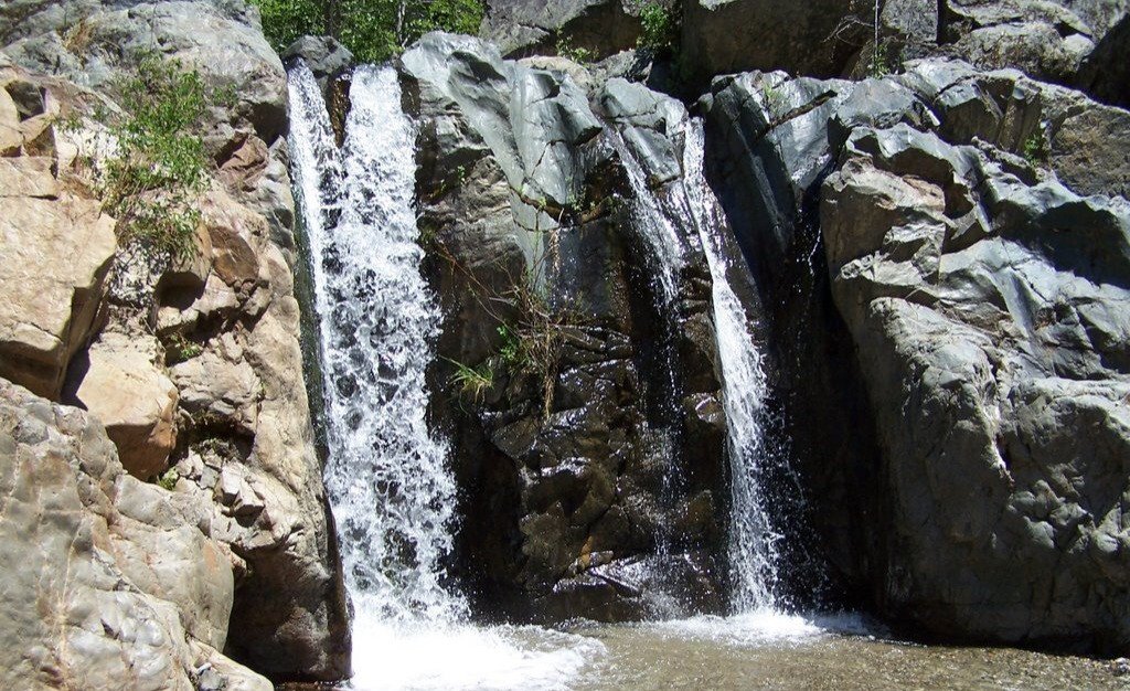 Album by Kenley & Erik with the username @KenleyandErik, who is a verified user,  September 3, 2024 at 12:00 PM and the text says 'Another pic from our favorite river spot. This waterfall feels amazing'