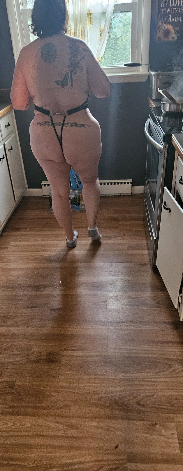 Album by BothWaysEntwined with the username @BothWaysEntwined, who is a verified user,  May 2, 2024 at 11:31 PM and the text says 'Her turn to cook "mostly" naked. Damn she's sexy!!  🔥🔥🤤🔥🔥 We need one of our Big Dick followers to come fuck us 🍆💦💦🍑🍑 #hotwife #bisexual #amateur #nude'