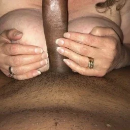 Shared Photo by Foxywifey1975 with the username @Foxywifey1975, who is a verified user,  April 9, 2024 at 11:19 PM. The post is about the topic Cuckold and Hotwife Corner and the text says 'Hubby loves seeing another man's cock between my boobs'