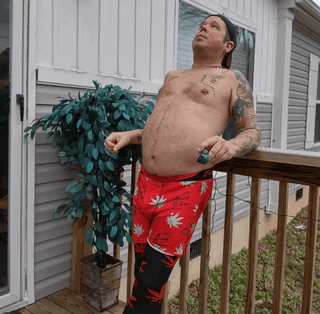 Photo by TheJTLovecraft with the username @TheJTLovecraft, who is a verified user,  July 7, 2024 at 5:31 PM and the text says 'Who wants to get high and have some fun? #dadbod #tattoos'