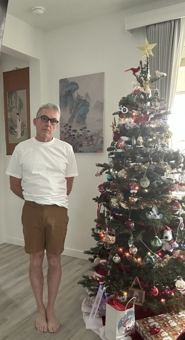 Album by Maturedad with the username @Maturedad, who is a verified user,  December 11, 2024 at 12:54 AM and the text says 'Daddy making me pose by the tree. Merry Christmas! 🎄'