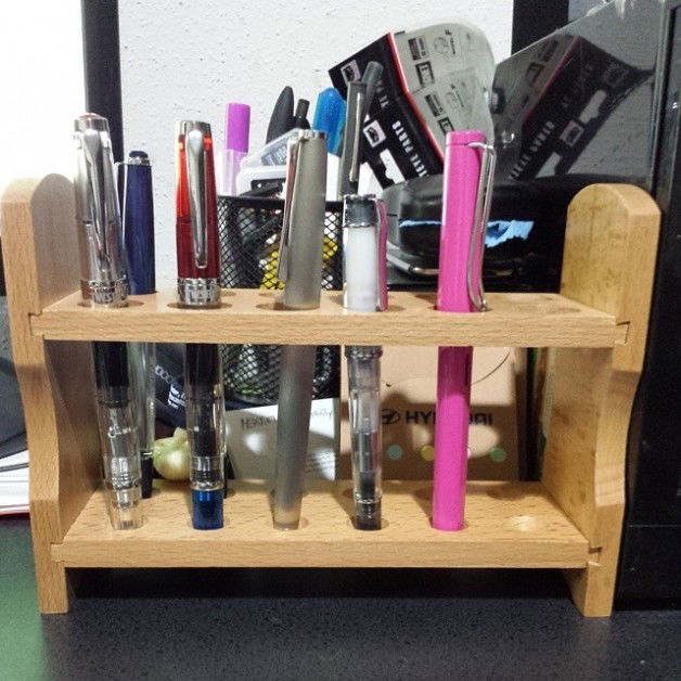 Photo by Jadehawk with the username @Jadehawk,  August 7, 2014 at 10:56 PM and the text says 'Could not look  at my fountain pens rolling on the desk anymore. So I got them an inexpensive test tube holder. It does the job pretty well :)'