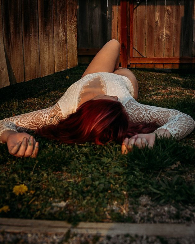 Photo by Bookish with the username @Bookish,  May 8, 2021 at 11:19 PM and the text says '#outdoors #lingerie #lace #redhair'