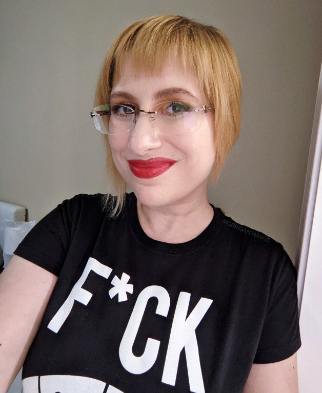 Photo by Morrigan Havoc with the username @LadyMorrigan, who is a star user,  October 5, 2023 at 9:58 PM. The post is about the topic MILF and the text says 'Can you guess what my t-shirt is saying? 
Hint: what you can already see is the first word, there's more to it'