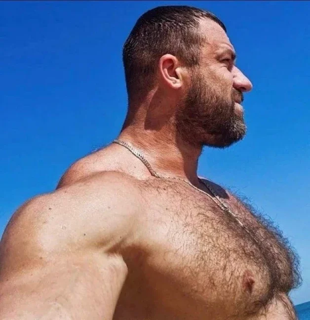 Photo by Nickplus33 with the username @Nickplus33, who is a verified user,  March 21, 2024 at 3:10 AM and the text says '#beefy #bear #outdoors #hairy #dilf #daddy #beard #chain'
