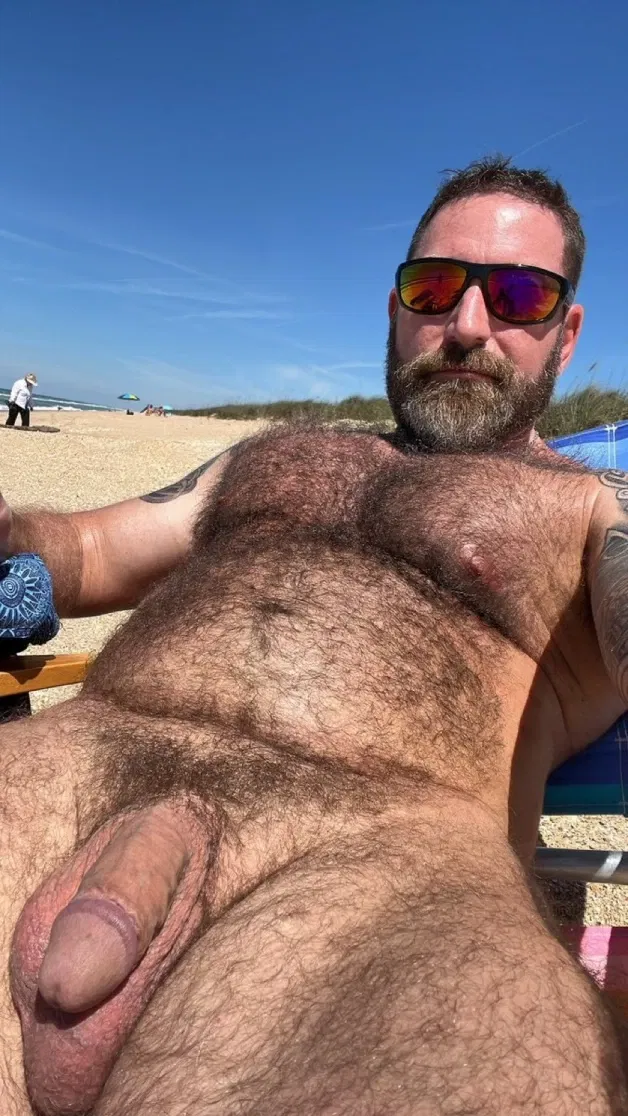 Photo by Nickplus33 with the username @Nickplus33, who is a verified user,  April 11, 2024 at 3:14 AM and the text says '#beefy #shades #daddy #hung #bush #outdoors #ink #beach'