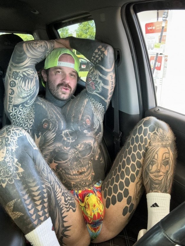 Photo by Nickplus33 with the username @Nickplus33, who is a verified user,  June 15, 2024 at 3:00 AM and the text says '#muscled #ink #car #caps #bulge #cruising #manspread  #Durden #scruff #stache'
