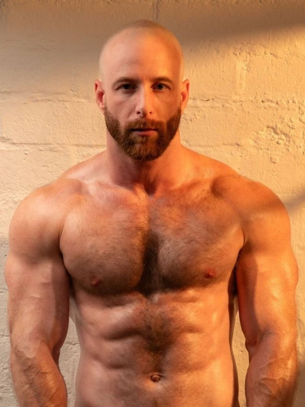 Photo by Nickplus33 with the username @Nickplus33, who is a verified user,  May 3, 2024 at 3:15 AM and the text says '#muscled #hairy #hairychest #beard #bald #dilf'