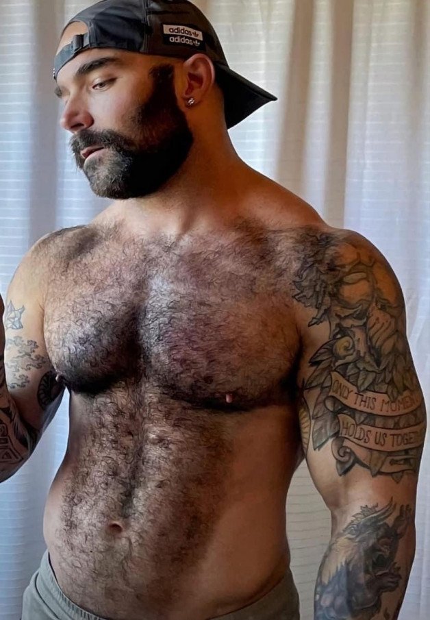 Photo by Nickplus33 with the username @Nickplus33, who is a verified user,  May 21, 2024 at 2:03 AM and the text says '#beard #hairy #ink #muscled #caps #hairychest'