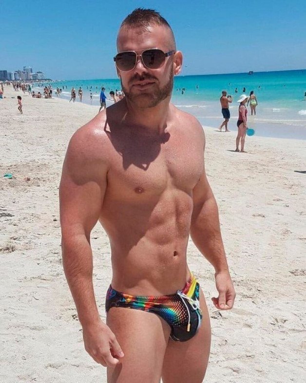 Photo by Nickplus33 with the username @Nickplus33, who is a verified user,  April 20, 2024 at 2:24 AM and the text says '#shades #outdoors #beach #youngdilf #muscled #smooth #bulge #scruff'