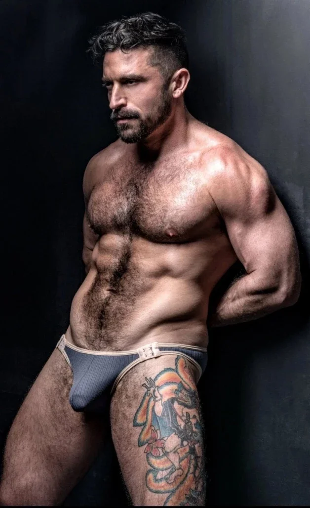 Photo by Nickplus33 with the username @Nickplus33, who is a verified user,  March 22, 2024 at 2:45 AM and the text says '#muscled #ink #bulge #daddy #dilf #beard #hairy'