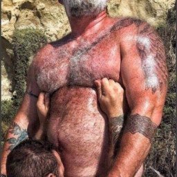 Photo by Nickplus33 with the username @Nickplus33, who is a verified user,  April 26, 2024 at 2:10 AM and the text says '#hairy #beard #dilf #shades #daddy #beefy #ink #outdoors #outdoorcruising #cocksucking #BJ'