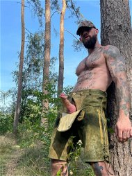 Shared Photo by Nickplus33 with the username @Nickplus33, who is a verified user,  October 29, 2023 at 4:43 PM and the text says '#man #dick #forest #lederhosen #baseball #hat ss-29-oct-23'