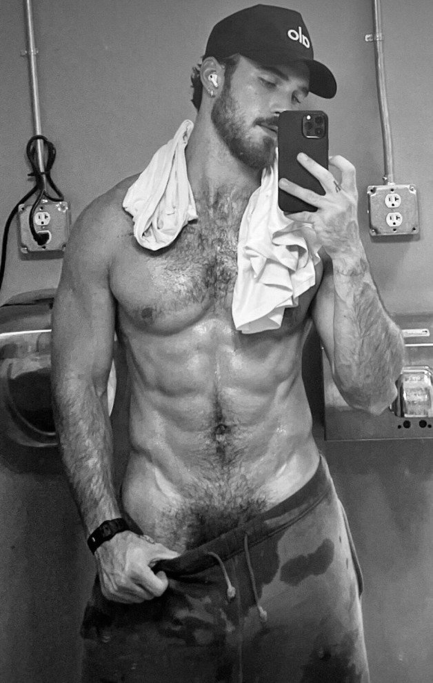 Photo by Nickplus33 with the username @Nickplus33, who is a verified user,  February 6, 2024 at 2:11 AM and the text says '#bw #youngdilf #hairy #beard #ripped #muscled #caps  #bush #selfies'