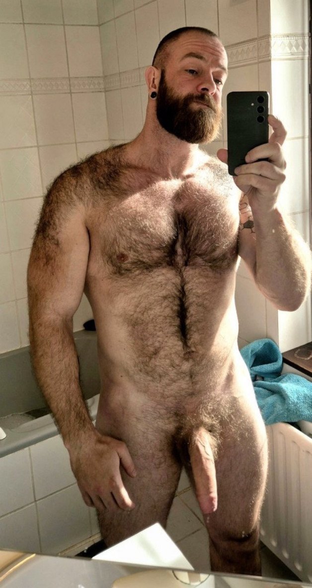 Photo by Nickplus33 with the username @Nickplus33, who is a verified user,  June 21, 2024 at 2:21 AM and the text says '#selfie #hung #hairy #longdick #uncut  #beard #hairychest #happytrail #dilf'