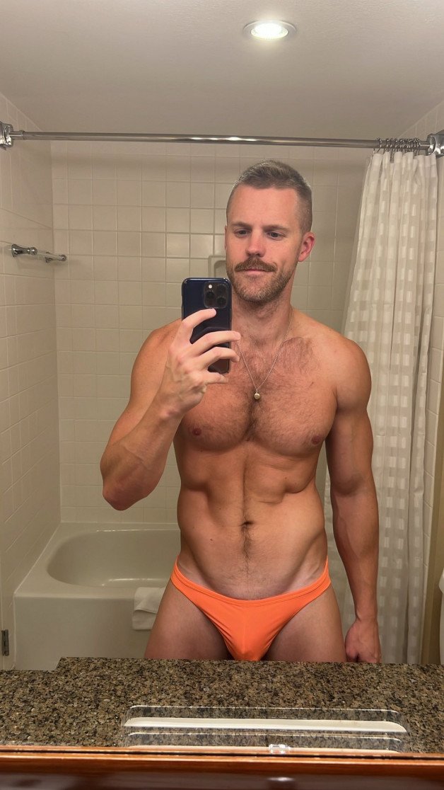 Photo by Nickplus33 with the username @Nickplus33, who is a verified user,  July 12, 2024 at 2:06 AM and the text says '#stache #scruff  #bulge  #chain #blondes #toned #hairychest #happytrail'