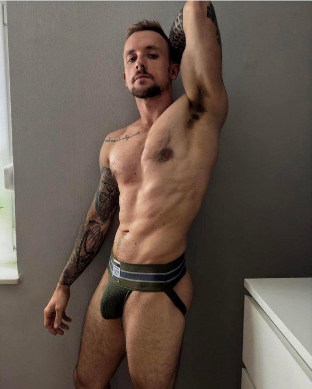 Photo by Nickplus33 with the username @Nickplus33, who is a verified user,  April 28, 2024 at 2:59 AM and the text says '#bush #jockstrap #beard #ink #youngdilf #bulge #toned'