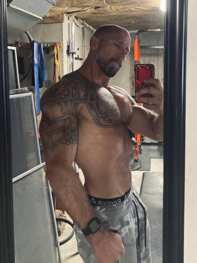Photo by Nickplus33 with the username @Nickplus33, who is a verified user,  April 21, 2024 at 4:04 AM and the text says '#daddy #muscled #hairy #hairychest #bald #selfie #beard #ink'