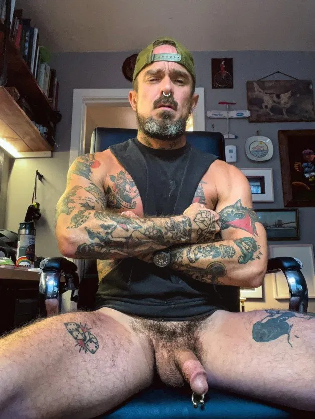 Photo by Nickplus33 with the username @Nickplus33, who is a verified user,  November 3, 2023 at 2:53 AM and the text says '#daddy #dilf #caps #PA #manspread #ink #bush #beard'