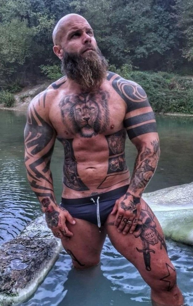 Photo by Nickplus33 with the username @Nickplus33, who is a verified user,  May 20, 2024 at 3:32 AM and the text says '#ink #daddy #muscled #outdoors #beard #bald #band'