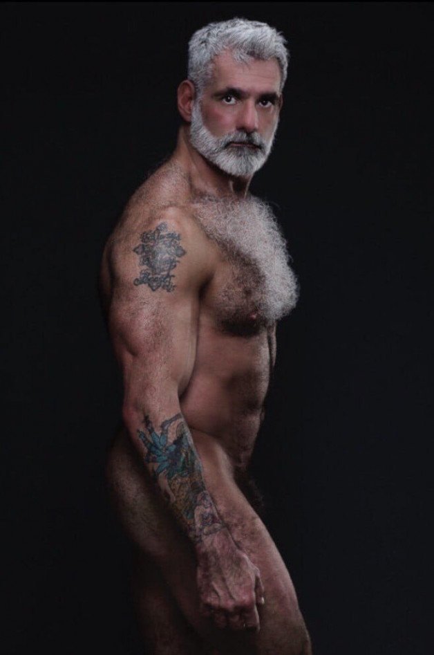 Photo by Nickplus33 with the username @Nickplus33, who is a verified user,  October 19, 2023 at 2:17 PM and the text says '#daddy #beard #ink #muscled'