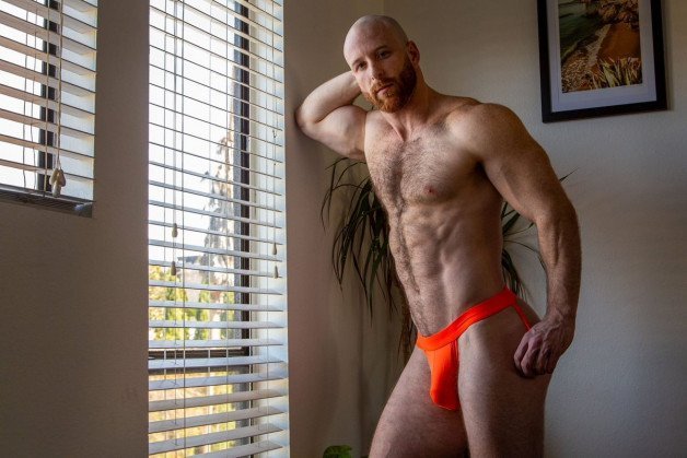 Photo by Nickplus33 with the username @Nickplus33, who is a verified user,  March 9, 2024 at 4:16 AM and the text says '#jockstrap #bulge #beard #ginger #dilf #hairy #muscled #hotAF'