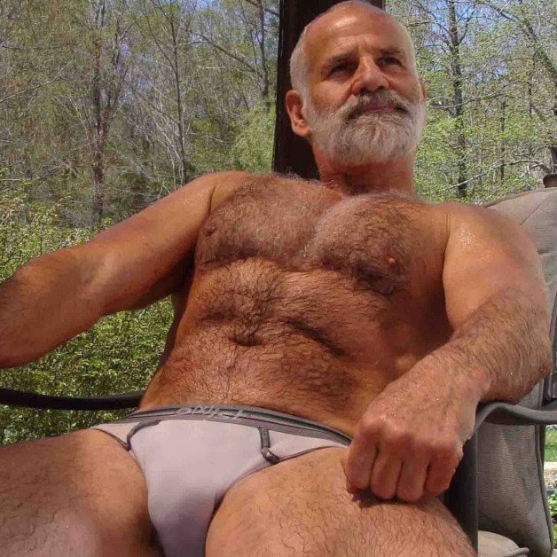 Photo by Nickplus33 with the username @Nickplus33, who is a verified user,  July 12, 2024 at 2:20 AM and the text says '#granddaddy #silverfox #daddy #outdoors #hairy #toned #briefs #beard #bald #manspread'