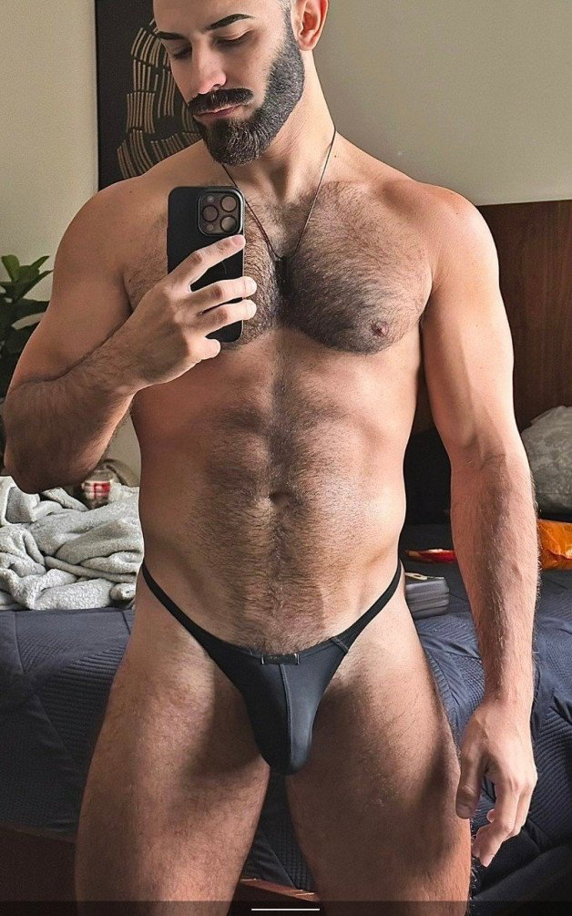 Photo by Nickplus33 with the username @Nickplus33, who is a verified user,  June 23, 2024 at 3:24 AM and the text says '#bulge #chain #hairychest #hairy #beard #selfie #dilf #toned'