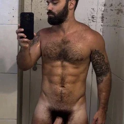 Photo by Nickplus33 with the username @Nickplus33, who is a verified user,  May 3, 2024 at 3:35 AM and the text says '#dilf #selfie #hairychest #toned #beard #thickdick #thickbush'