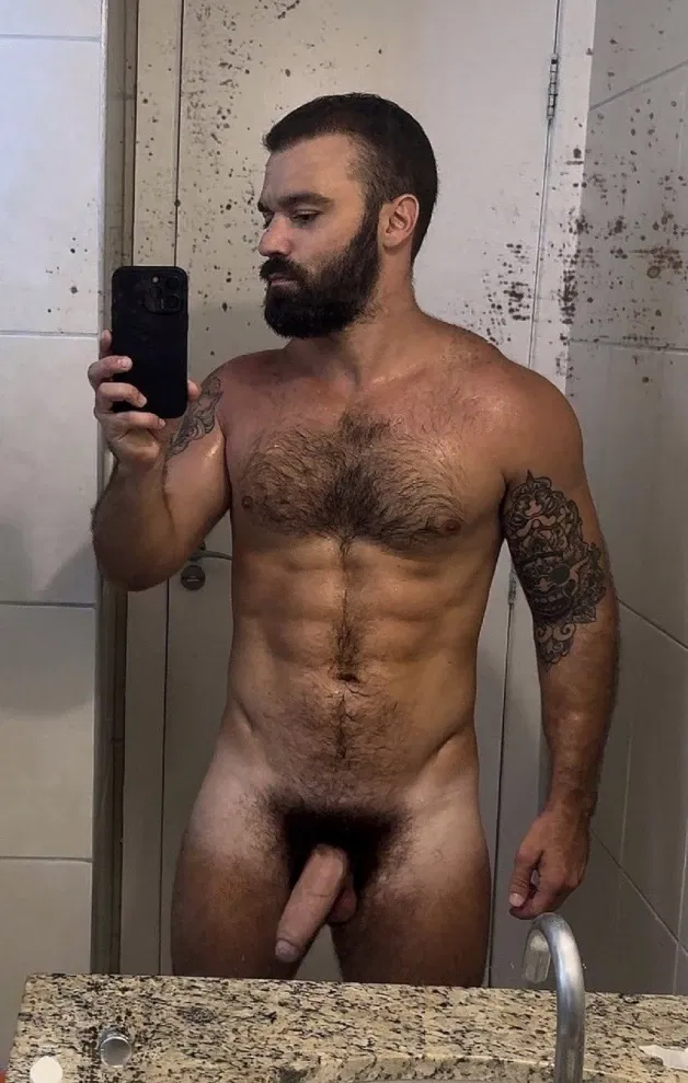 Photo by Nickplus33 with the username @Nickplus33, who is a verified user,  May 3, 2024 at 3:35 AM and the text says '#dilf #selfie #hairychest #toned #beard #thickdick #thickbush'