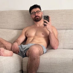 Photo by Nickplus33 with the username @Nickplus33, who is a verified user,  May 13, 2024 at 5:05 AM and the text says '#specs #selfie #otter  #smooth #beard #toned #muscled'