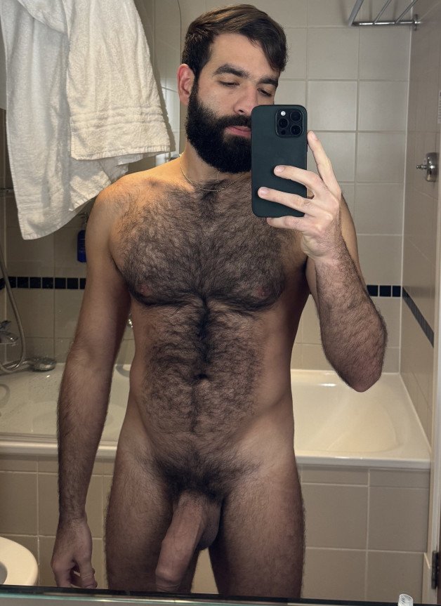 Photo by Nickplus33 with the username @Nickplus33, who is a verified user,  May 27, 2024 at 2:32 AM and the text says '#selfie #hairy #beard #youngdilf #hung #massivecock #uncut  #longdick #thickdick #chain'