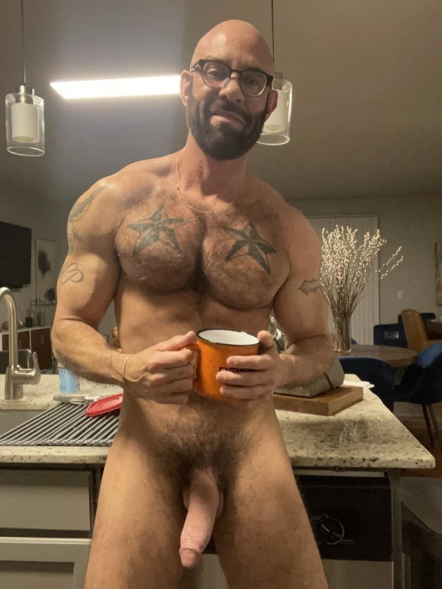 Photo by Nickplus33 with the username @Nickplus33, who is a verified user,  March 22, 2024 at 2:38 AM and the text says '#coffee #beard #dilf #specs #beard #bald #ink #hairy #longdick'
