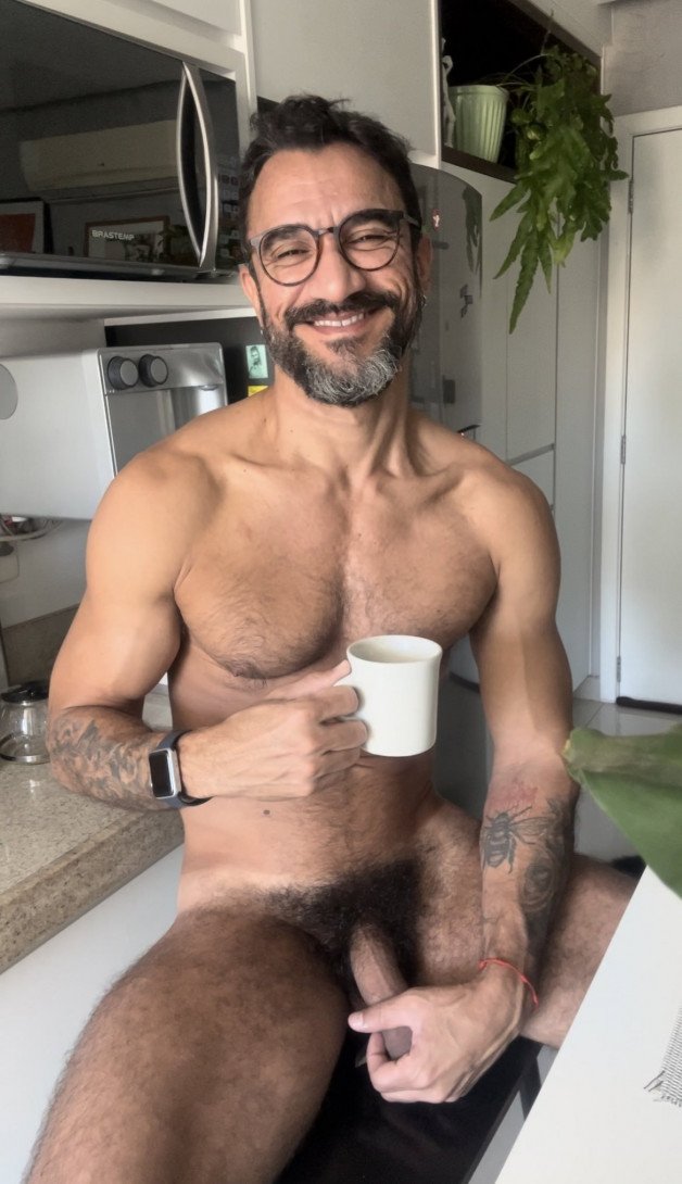 Photo by Nickplus33 with the username @Nickplus33, who is a verified user,  July 11, 2024 at 2:55 AM and the text says '#dilf #daddy #specs #coffee #manspread  #thickbush #toned #hairy #trimmed  #beard'